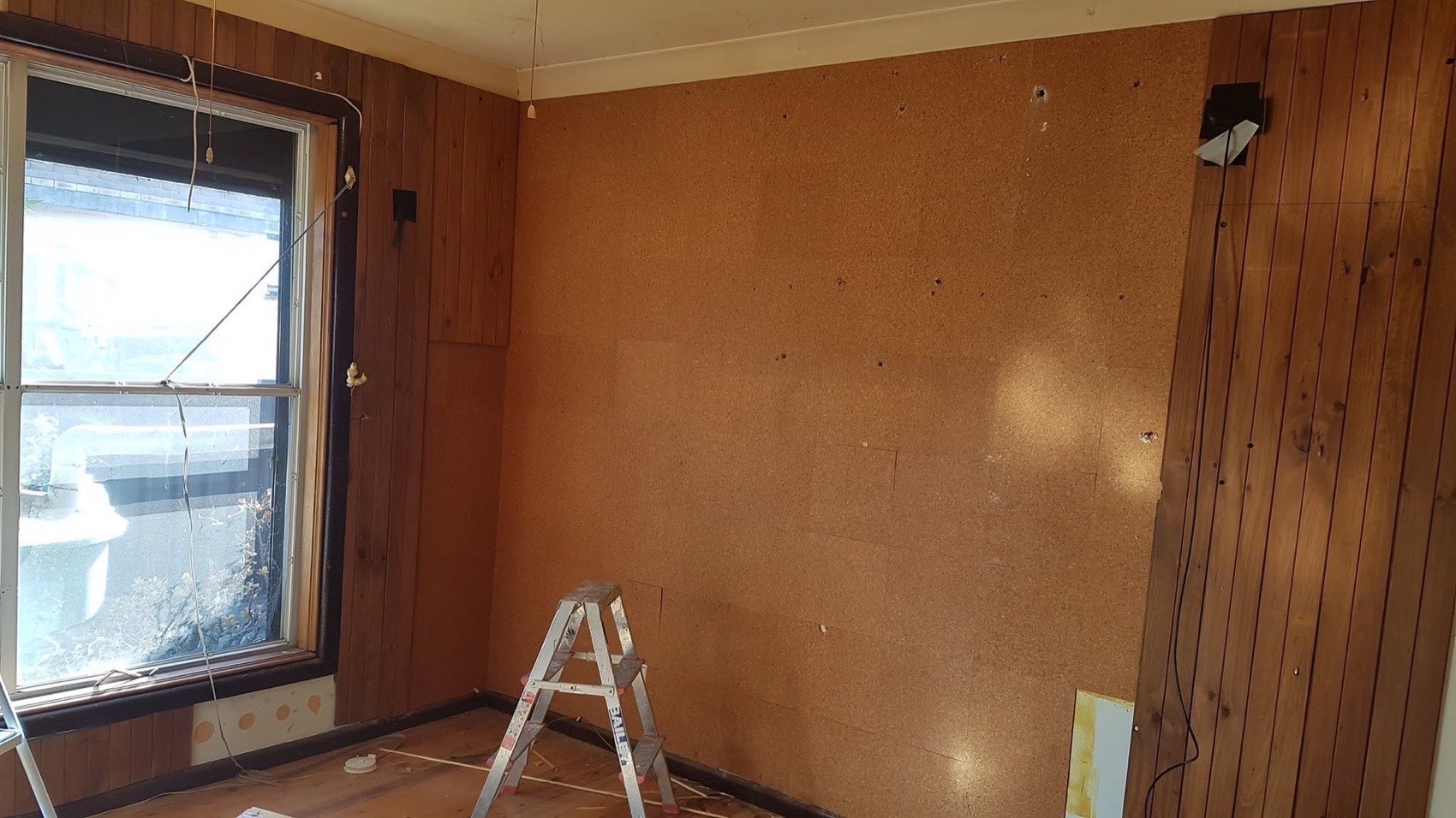 A room part way through being lined with new timber boards