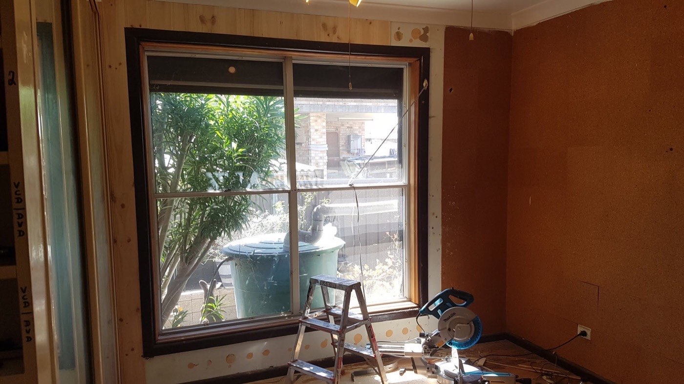 An interior wall being lined with new timber boards beside a stepladder