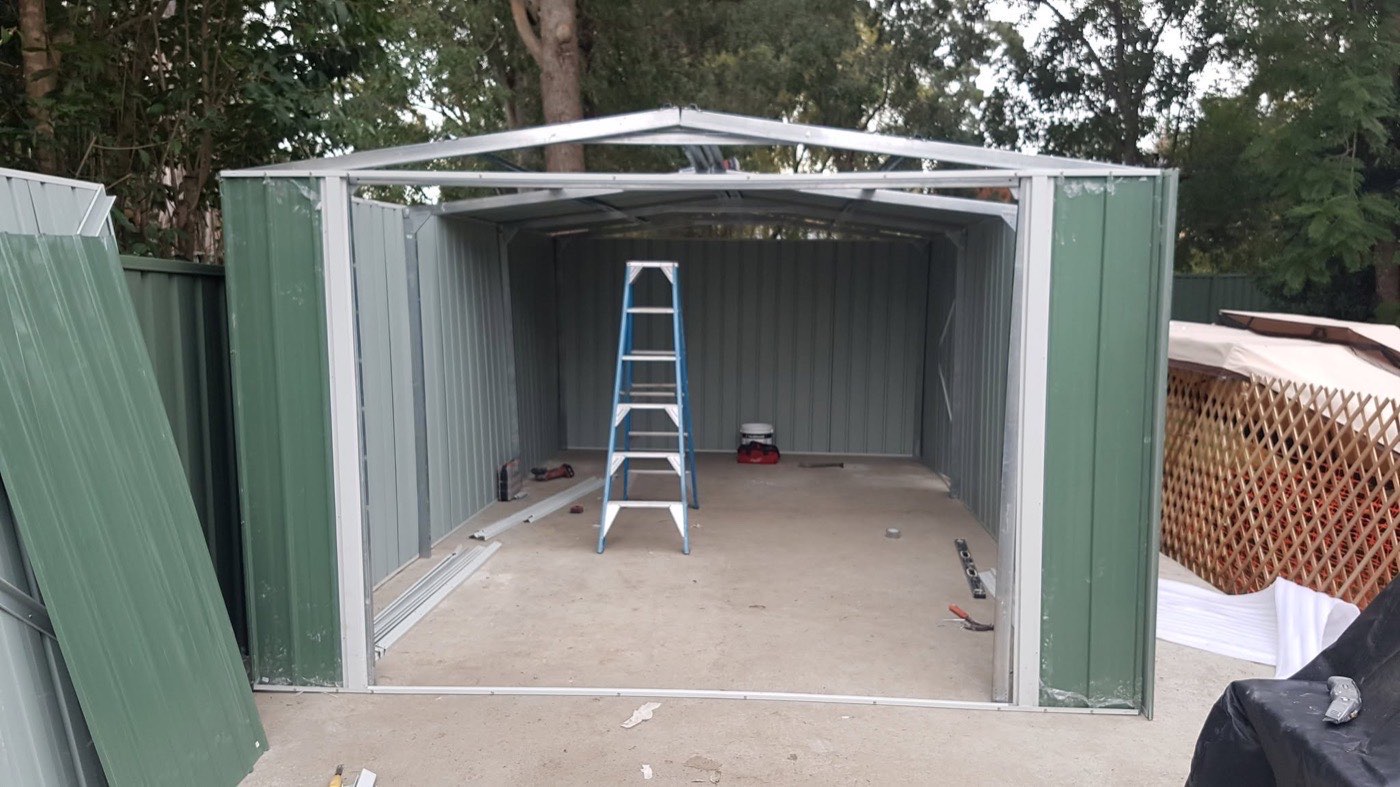 The inside of a newly assembled garden shed with the doors open
