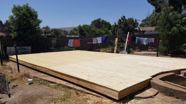 A large new timber deck platform built across a backyard
