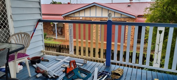 Tools laid out on a veranda deck beside new balustrade timber