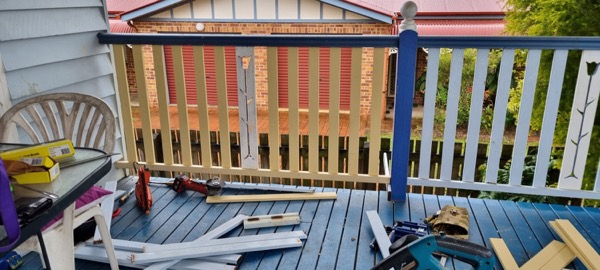 New balustrade rails being fitted along a veranda edge