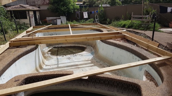 Deck bearers spanning an old pool shell