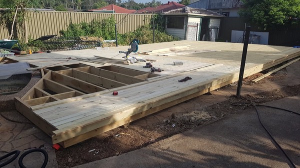 A subfloor frame laid over an old pool and the surrounding paving
