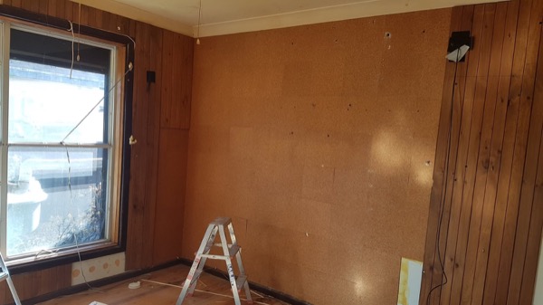 A room lined with new timber boards around a window