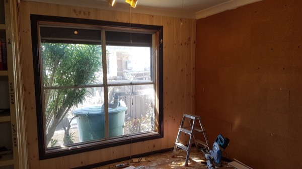 New timber wall lining around a black-framed window