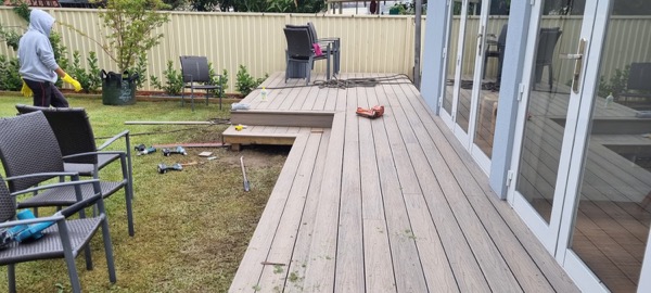 A timber deck being built along the back of a house