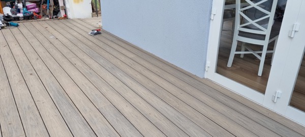 A completed timber deck running along a rear wall