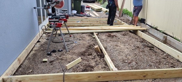 A deck frame being set out on levelled ground