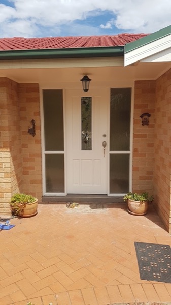 A brick home entry with a newly fitted front door